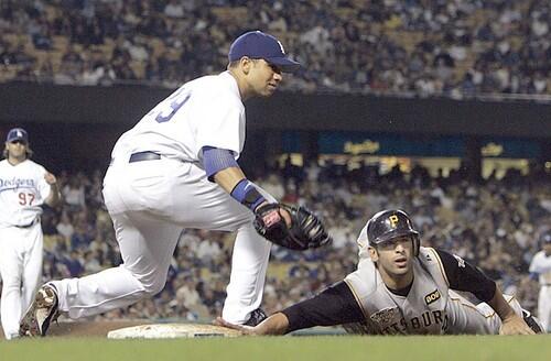 Dodgers first baseman James Loney picks off Pirates Jose Bautista as pitcher Joe Beimel makes the throw.