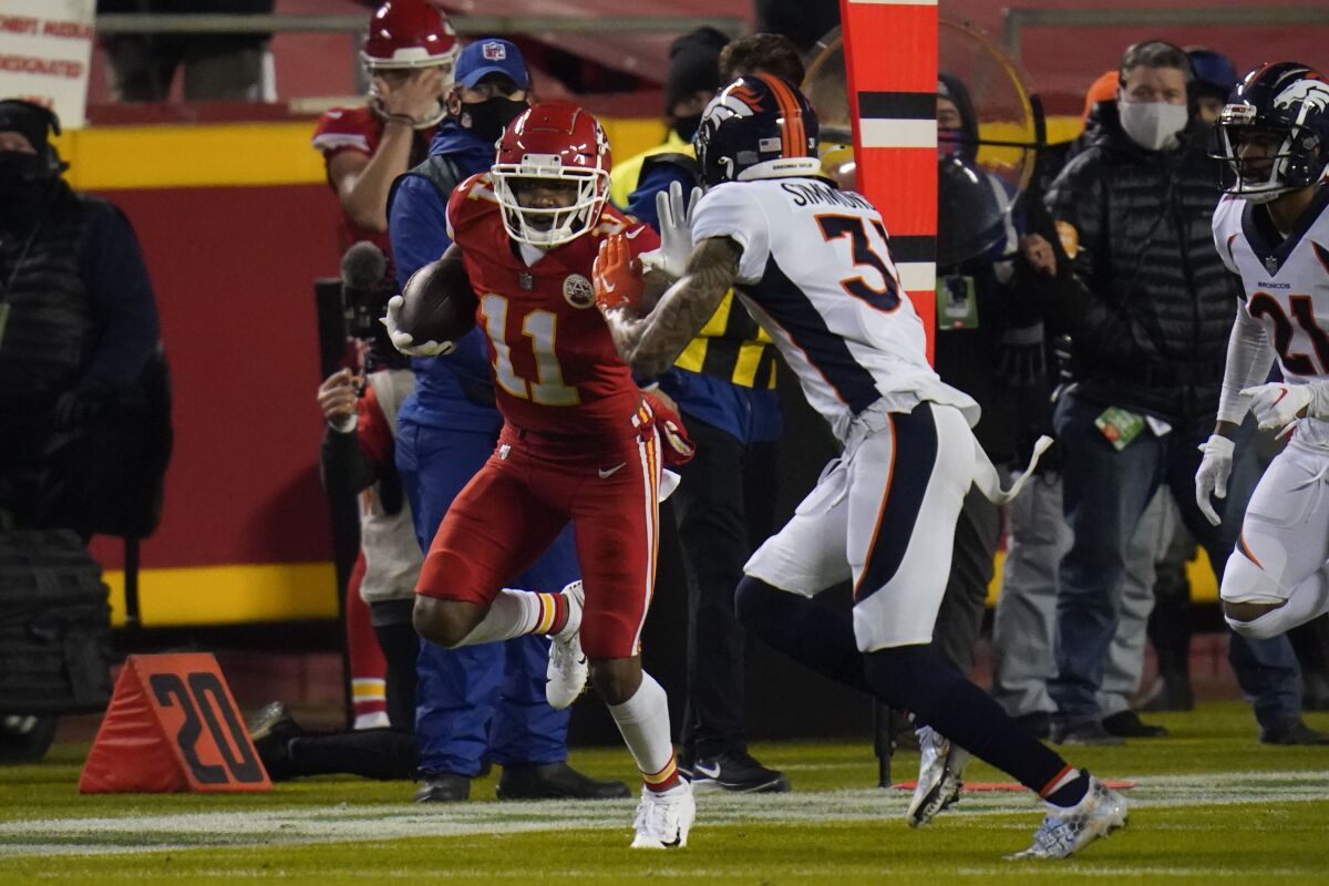 Kansas City Chiefs wide receiver Demarcus Robinson (11) runs after a catch as Denver Broncos free safety Justin Simmons (31) defends in the first half of an NFL football game in Kansas City, Mo., Sunday, Dec. 6, 2020. (AP Photo/Jeff Roberson)