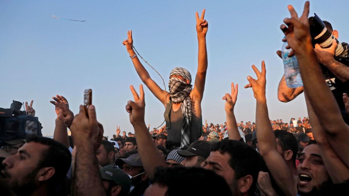 Supporters of Hamas leader Ismail Haniyeh react during his speech near the border with Israel east of Gaza City on May 15.