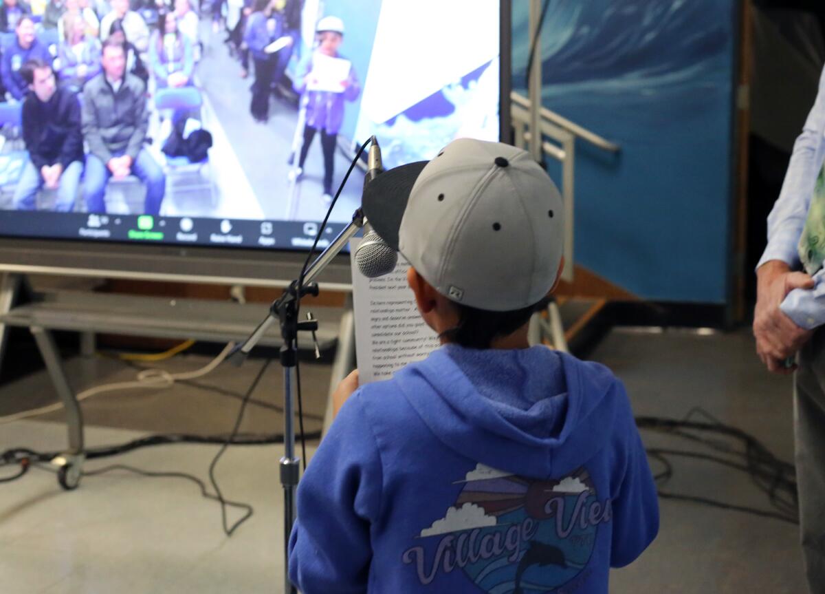 Village View Elementary fourth-grader Santiago Medina reads a speech.