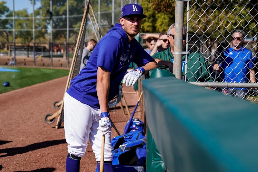 Dodgers outfielder Cody Bellinger watches during spring training Thursday at Camelback Ranch.
