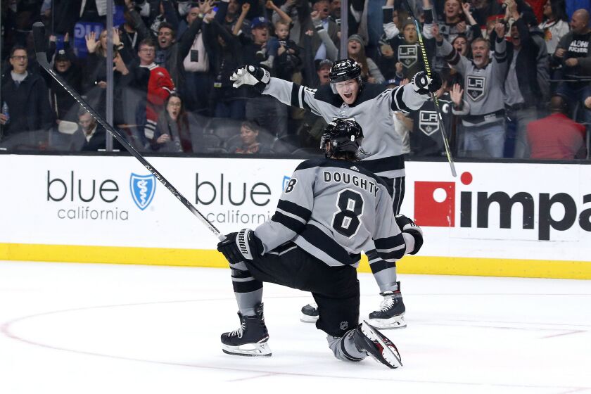 Los Angeles Kings defenseman Drew Doughty (8) celebrates his overtime goal with forward Tyler Toffoli in the team's NHL hockey game against the Chicago Blackhawks on Saturday, Nov. 2, 2019, in Los Angeles. The Kings won 4-3. (AP Photo/Ringo H.W. Chiu)