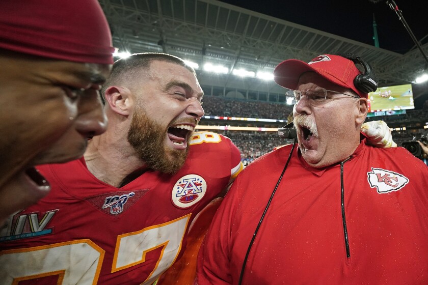 FILE - In this Feb. 2, 2020, file photo, Kansas City Chiefs' Travis Kelce, left, celebrates with head coach Andy Reid after defeating the San Francisco 49ers in the NFL Super Bowl 54 football game in Miami Gardens, Fla. The photo was part of a series of images by photographer David J. Phillip which won the Thomas V. diLustro best portfolio award for 2020 given out by the Associated Press Sports Editors during their annual winter meeting. (AP Photo/David J. Phillip, File)