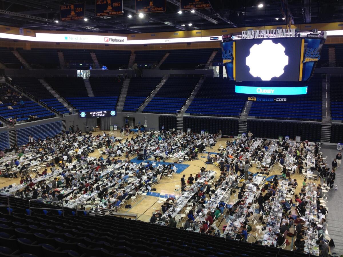 College students pack onto the floor of UCLA's Pauley Pavilion for the the LA Hacks hackathon.
