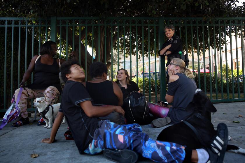 LOS ANGELES, CA-OCTOBER 29, 2019: LAPD Sgt. Shannon Geaney checks in on a group of homeless people and provides them with guidance and support on October 29, 2019 in Los Angeles, California. (Photo By Dania Maxwell / Los Angeles Times)