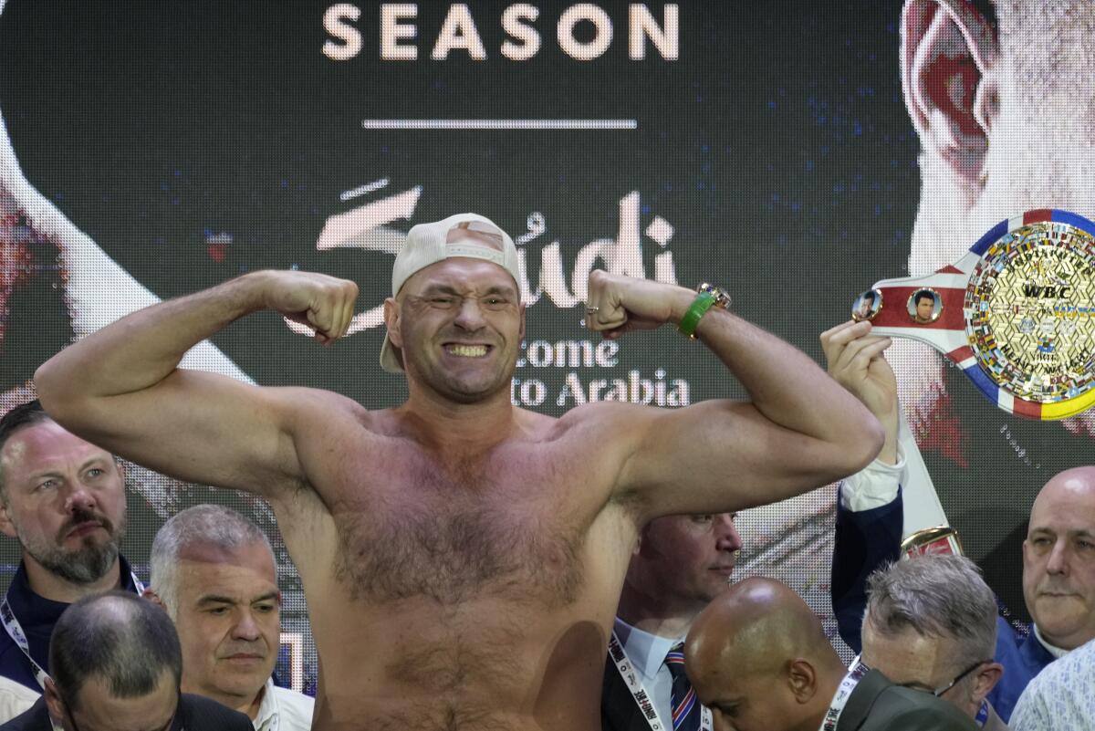 Heavyweight boxer Tyson Fury poses as he stands on the scales during a weigh-in in Riyadh, Saudi Arabia on Friday.