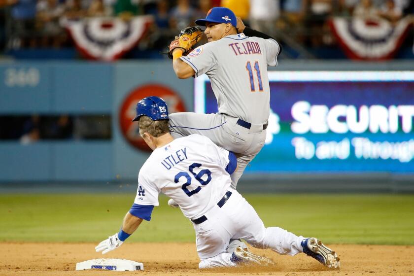 Dodgers' Chase Utley slides into New York Mets' Ruben Tejada on Saturday night.