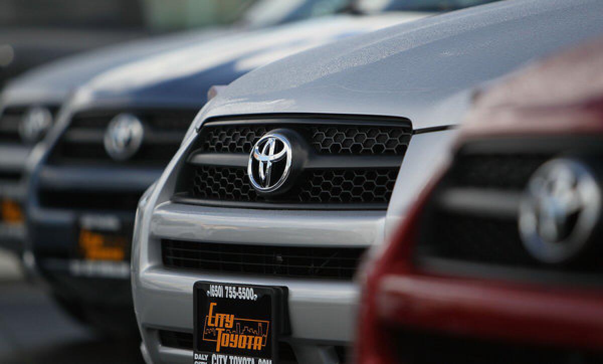The Toyota logo is displayed on the grill of brand new Toyota RAV4s on the sales lot at City Toyota in Daly City, California.