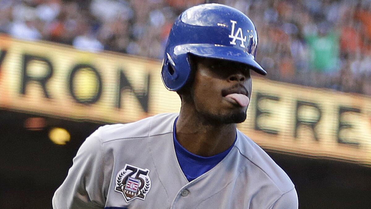 Dodgers second baseman Dee Gordon celebrates after scoring a run during the fifth inning of the team's 4-3 win over the San Francisco Giants on Sunday.