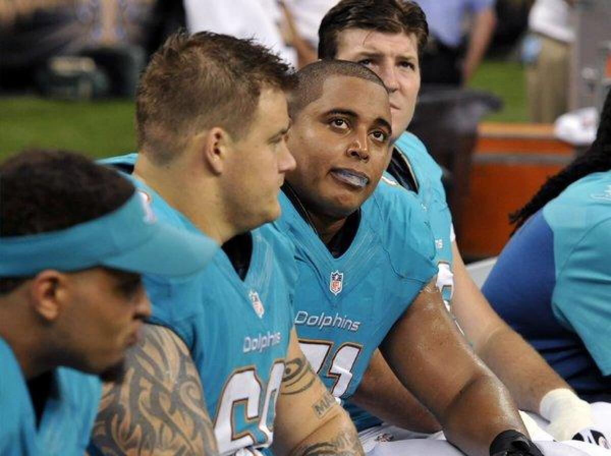 Miami Dolphins guard Richie Incognito (center left) and tackle Jonathan Martin (center right) sit on the bench in the second half of a game against the New Orleans Saints in September. Martin would later go on to accuse Incognito of bullying.