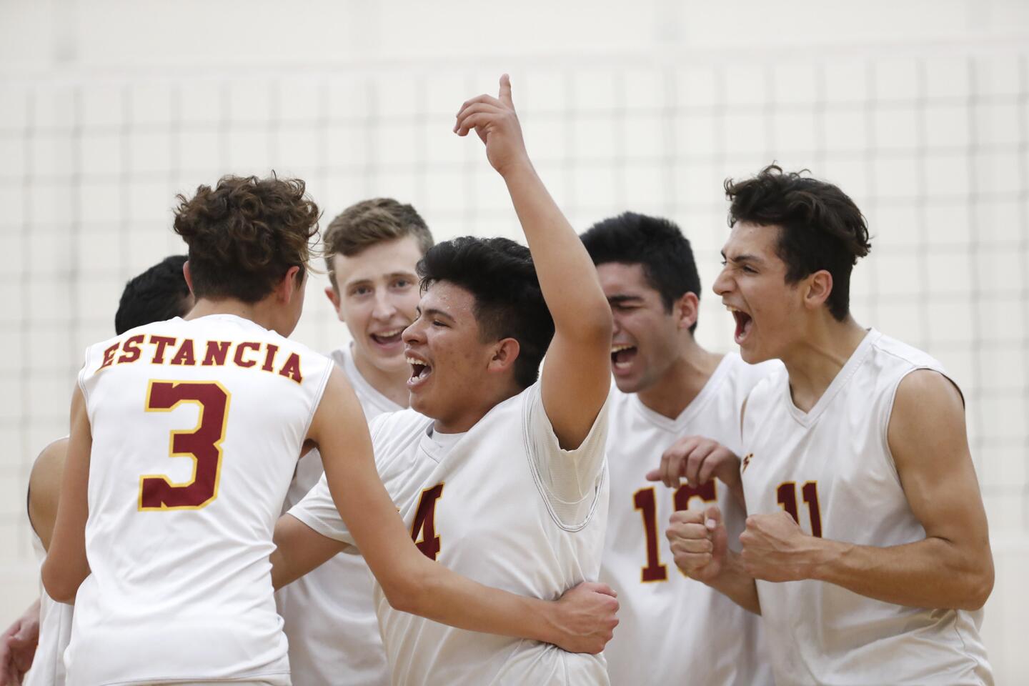 Estancia boys' volleyball team cheers after winning a point in game four against Costa Mesa on Tuesday, April 10.