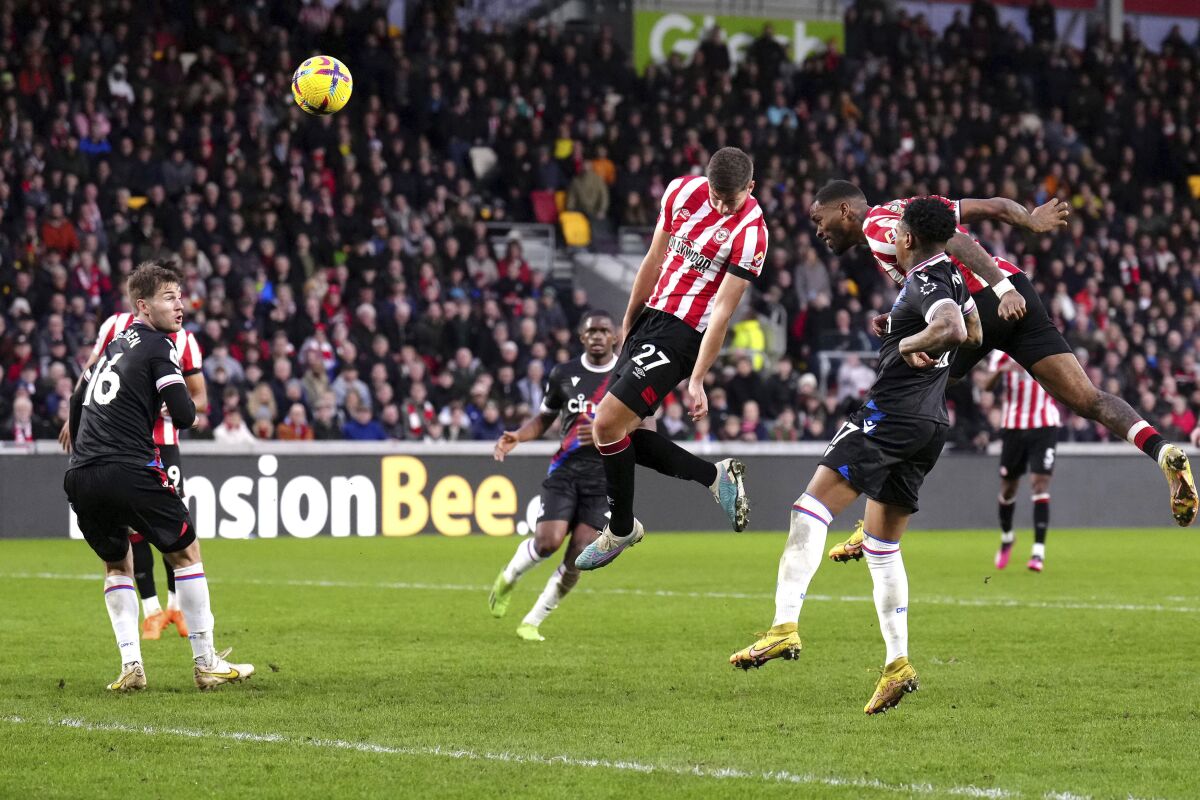 Brentford's Vitaly Janelt, center, scores their side's first goal of the game during the English Premier League soccer match against Crystal Palace at the Gtech Community Stadium, London, Saturday, Feb. 18, 2023. (Ben Whitley/PA via AP)