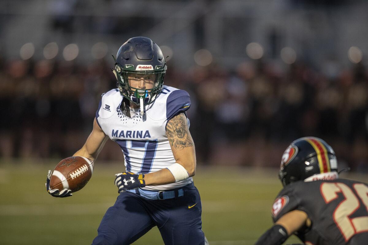 Marina's Gavin Dykema rushes up field against Segerstrom's Erik Martinez on Friday.