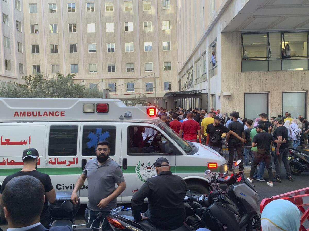 People gather outside the American University hospital 