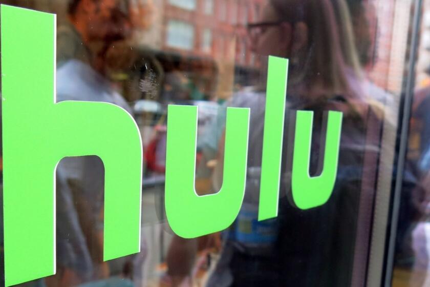 This Saturday, June 27, 2015 photo shows the Hulu logo on a window at the Milk Studios space in New York, where a replica of the "Seinfeld" set was on display, in New York. The cable network Epix jumped from Netflix to Hulu, the companies announced late Sunday, Aug. 30, 2015, landing a multiyear, digital subscription video on demand deal with the streaming service. (AP Photo/Dan Goodman) ORG XMIT: NYBZ105