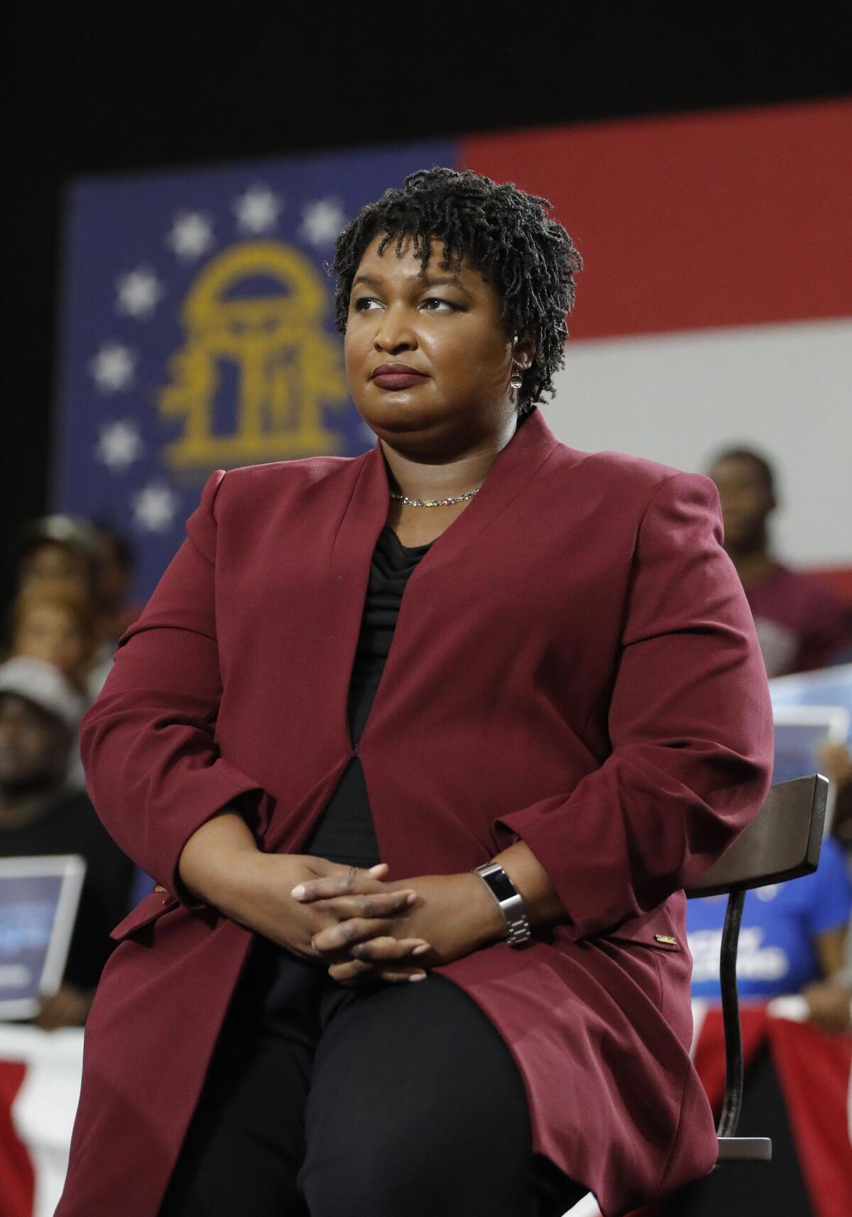 Stacey Abrams, watching President Barack Obama speak during a campaign rally in 2018.