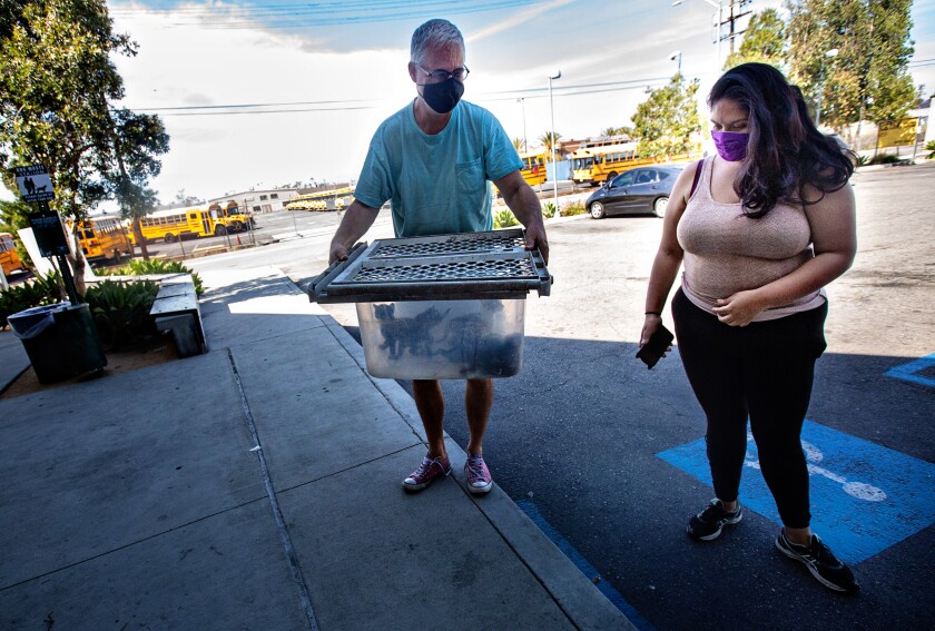 Paulina Valdivia and her father, Carlos Stouffler, bring stray kittens to the South L.A. animal shelter