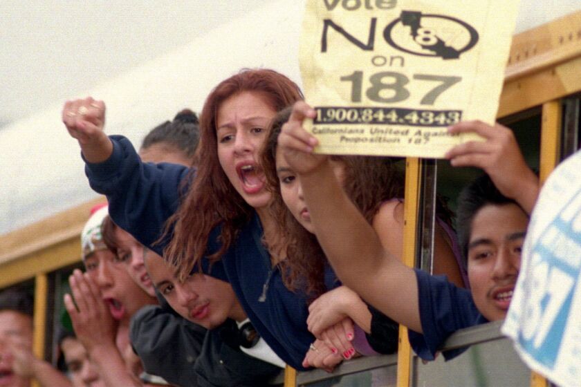 Students hang out the windows of a bus on Van Nuys Boulevard before their trip back to school after their walkout to protest Proposition 187 in November 1994.