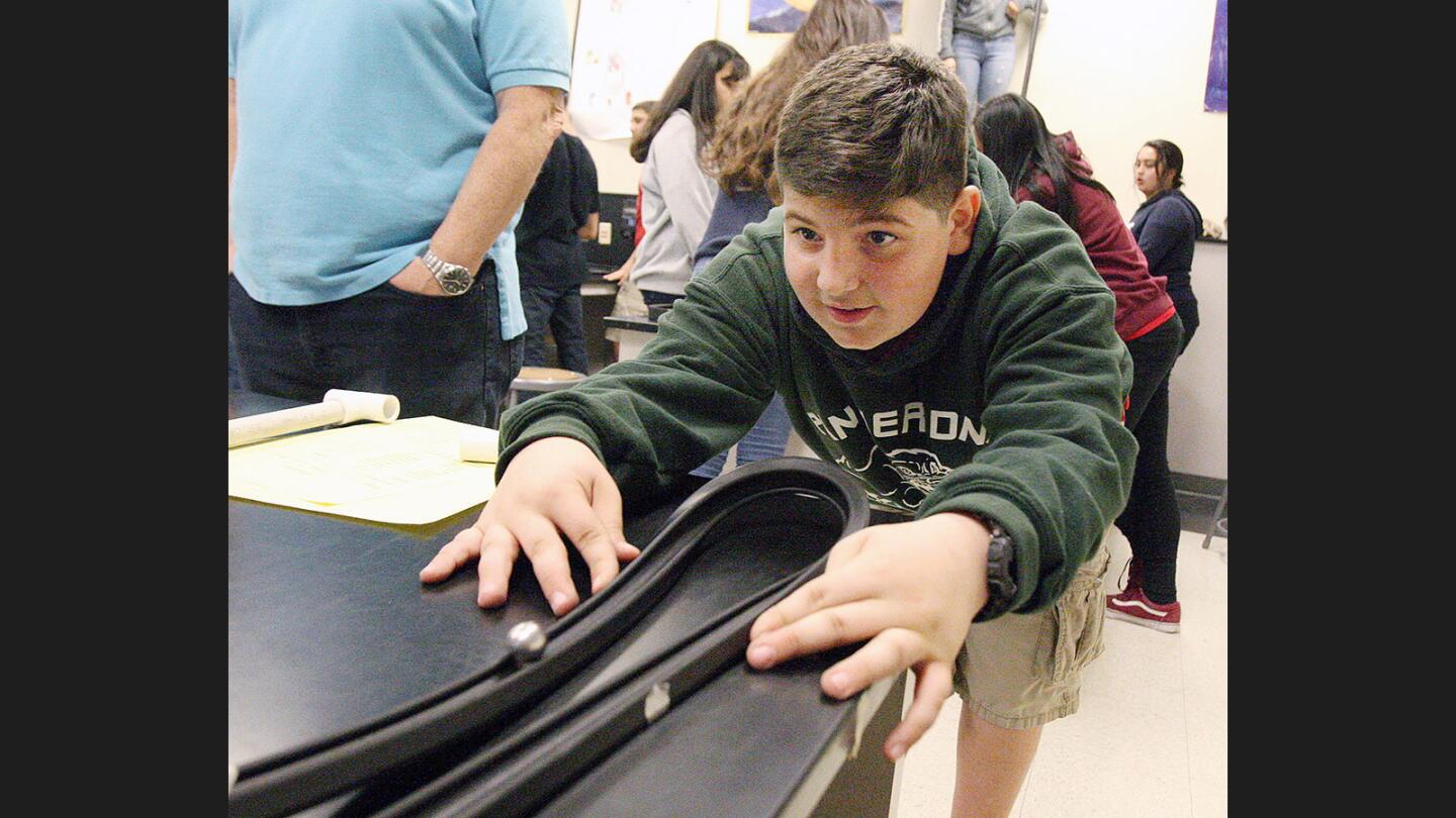 Photo Gallery: 8th grade Theodore Roosevelt Middle School students make roller coasters in physical science class