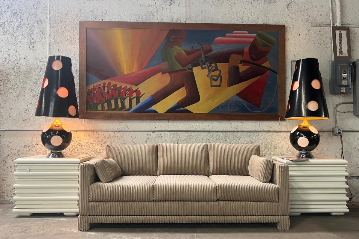 A tan corduroy couch under a graphic artwork