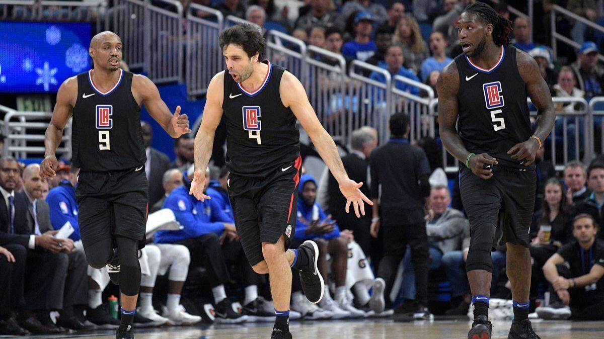 Clippers guard Milos Teodosic (4) celebrates after scoring while jogging up the court with guard C.J. Williams (9) and forward Montrezl Harrell (5) during the second half against the Orlando Magic on Wednesday.
