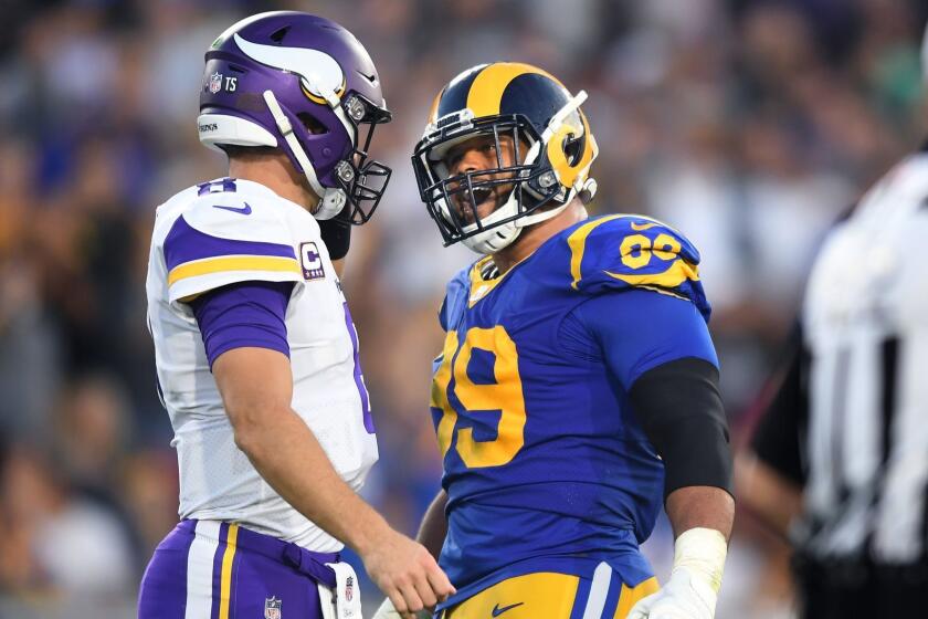 LOS ANGELES, SEPTEMBER 27, 2018-Rams defensive tackle Aaron Donald has a few words with Vikings quarterback Kirk Cousins inthe 2nd quarter at the Coliseum Thursday. (Wally Skalij/Los Angeles Times)