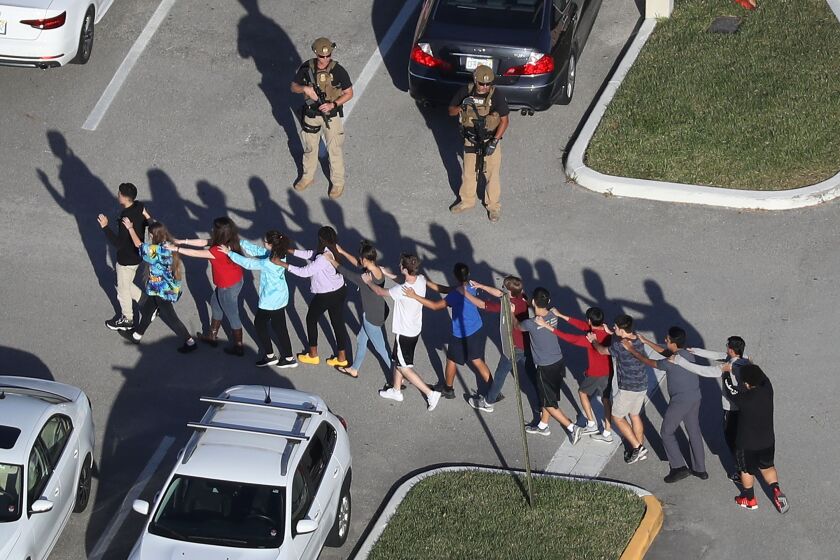 PARKLAND, FL - FEBRUARY 14: People are brought out of the Marjory Stoneman Douglas High School after a shooting at the school that reportedly killed and injured multiple people on February 14, 2018 in Parkland, Florida. Numerous law enforcement officials continue to investigate the scene. (Photo by Joe Raedle/Getty Images) ** OUTS - ELSENT, FPG, CM - OUTS * NM, PH, VA if sourced by CT, LA or MoD **