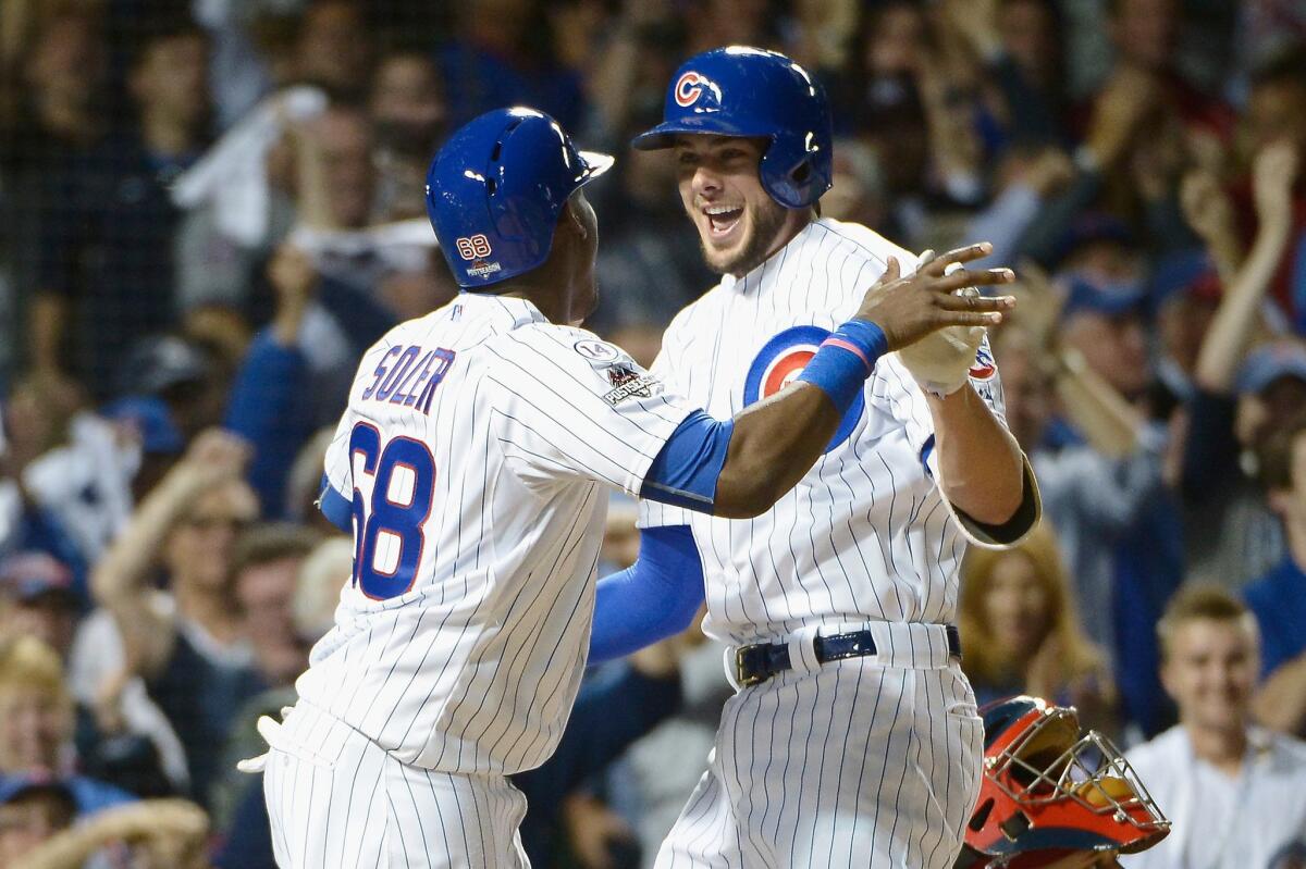 Cubs third baseman Kris Bryant celebrates with outfielder Jorge Soler after hitting a two-run home run in the fifth inning during Game 3 of the NLDS.