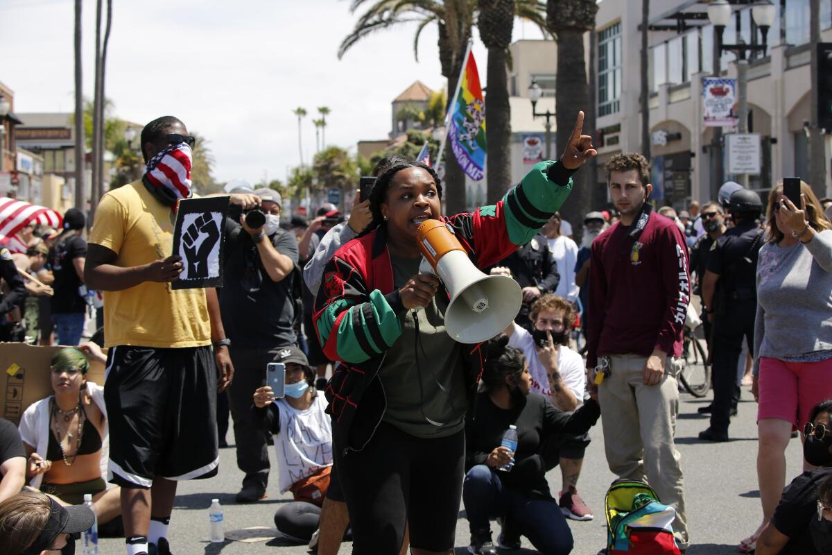 Kamelle Nandi, 30, of Huntington Beach speaks to the crowd during a Black Lives Matter protest in Huntington Beach.