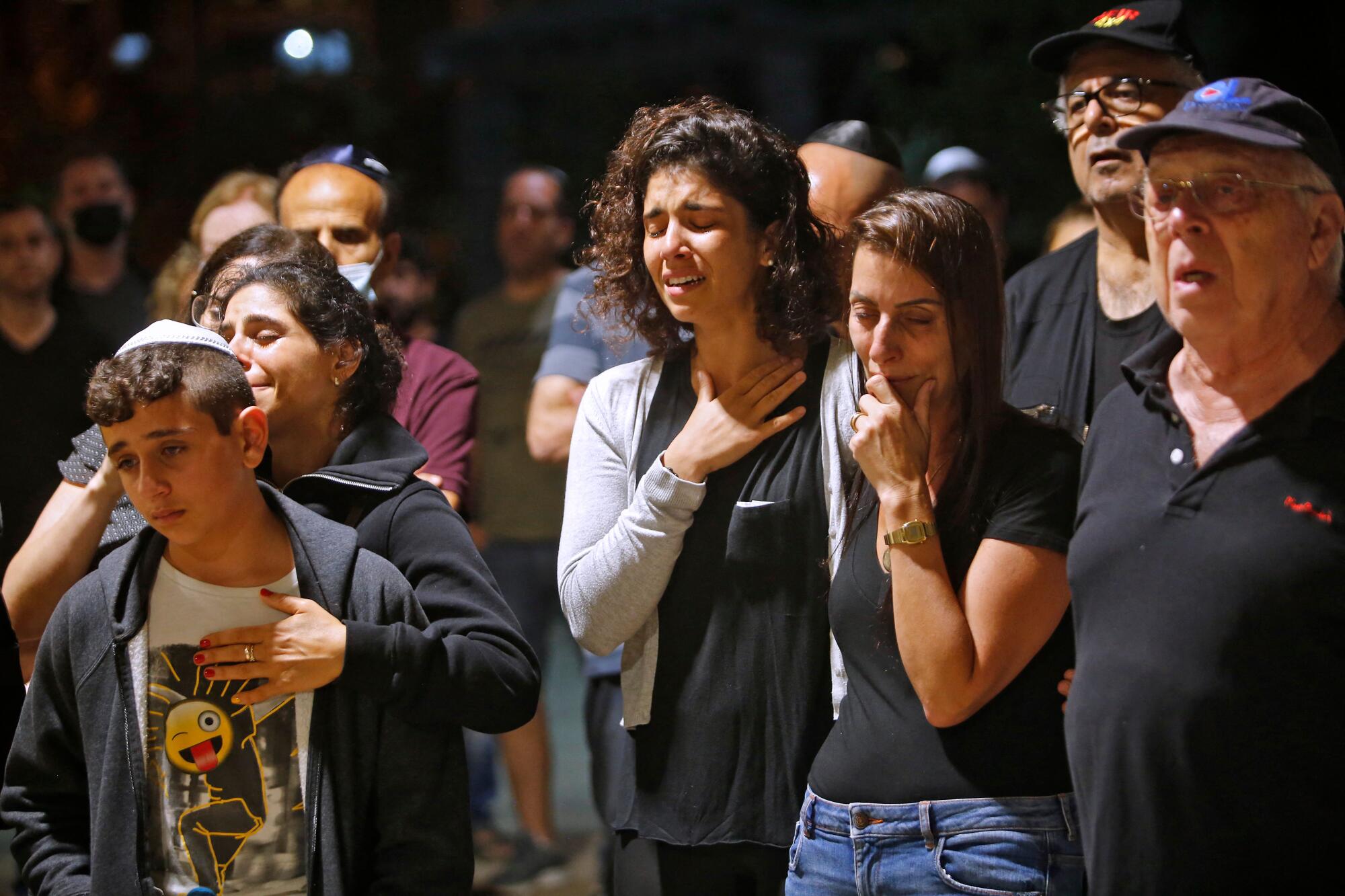 Mourners react during a funeral