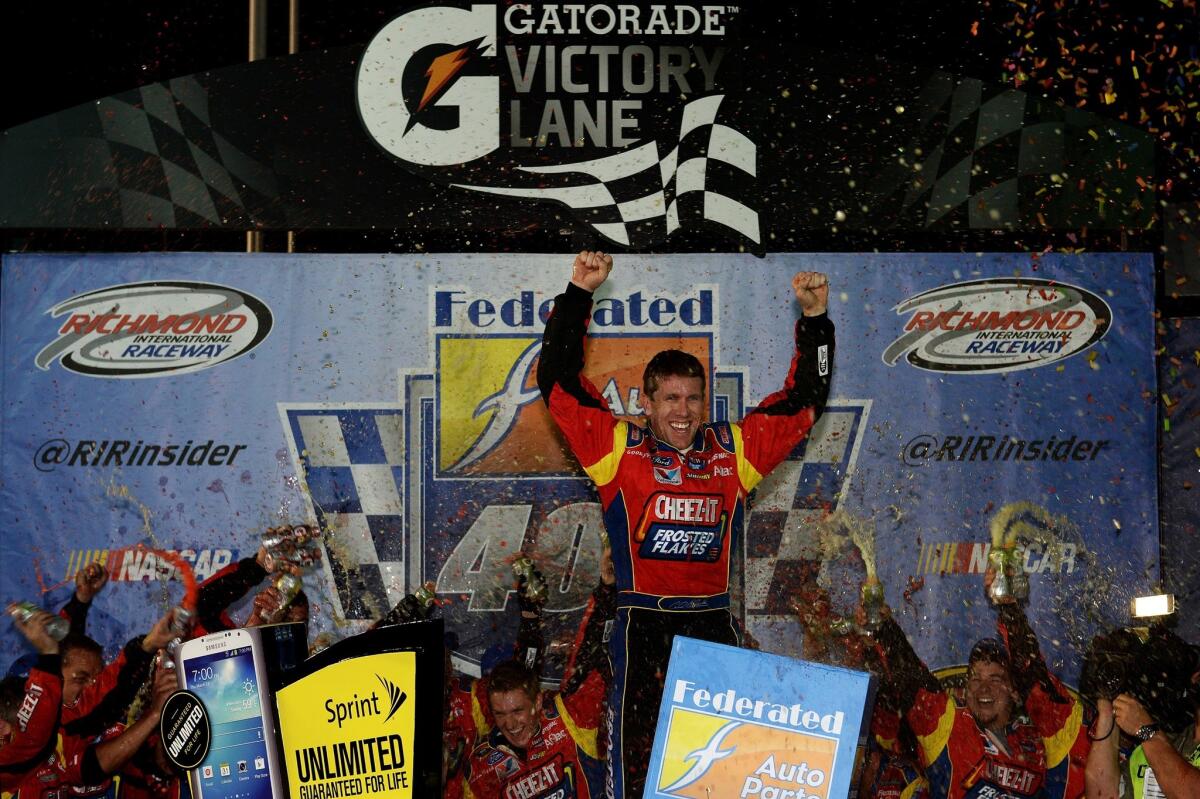 Carl Edwards celebrates after winning Saturday's NASCAR Sprint Cup race at Richmond International Raceway.