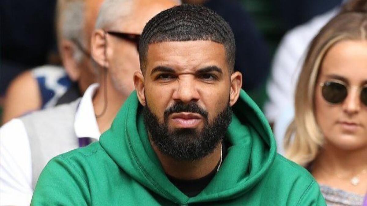 Rapper Drake sits on Centre Court at the 2018 Wimbledon Championships