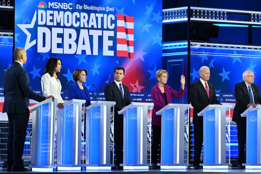 From left, Cory Booker, Tulsi Gabbard, Amy Klobuchar, Pete Buttigieg, Elizabeth Warren, Joe Biden and Bernie Sanders in Atlanta on Nov. 20.