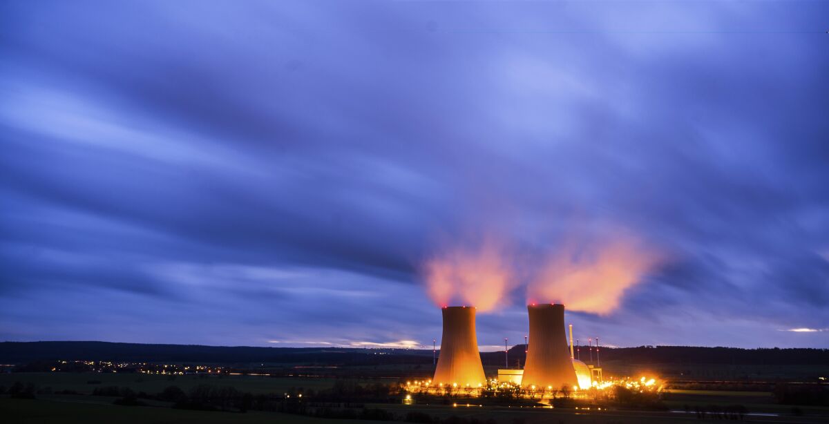 Steam rises from the cooling towers of the Grohnde nuclear power plant near Grohnde, Germany, Wednesday, Dec. 29, 2021. Germany on Friday, Dec. 31, 2021 is shutting down half of the six nuclear plants it still has in operation, a year before the country draws the final curtain on its decades-long use of atomic power. (Julian Stratenschulte/dpa via AP)