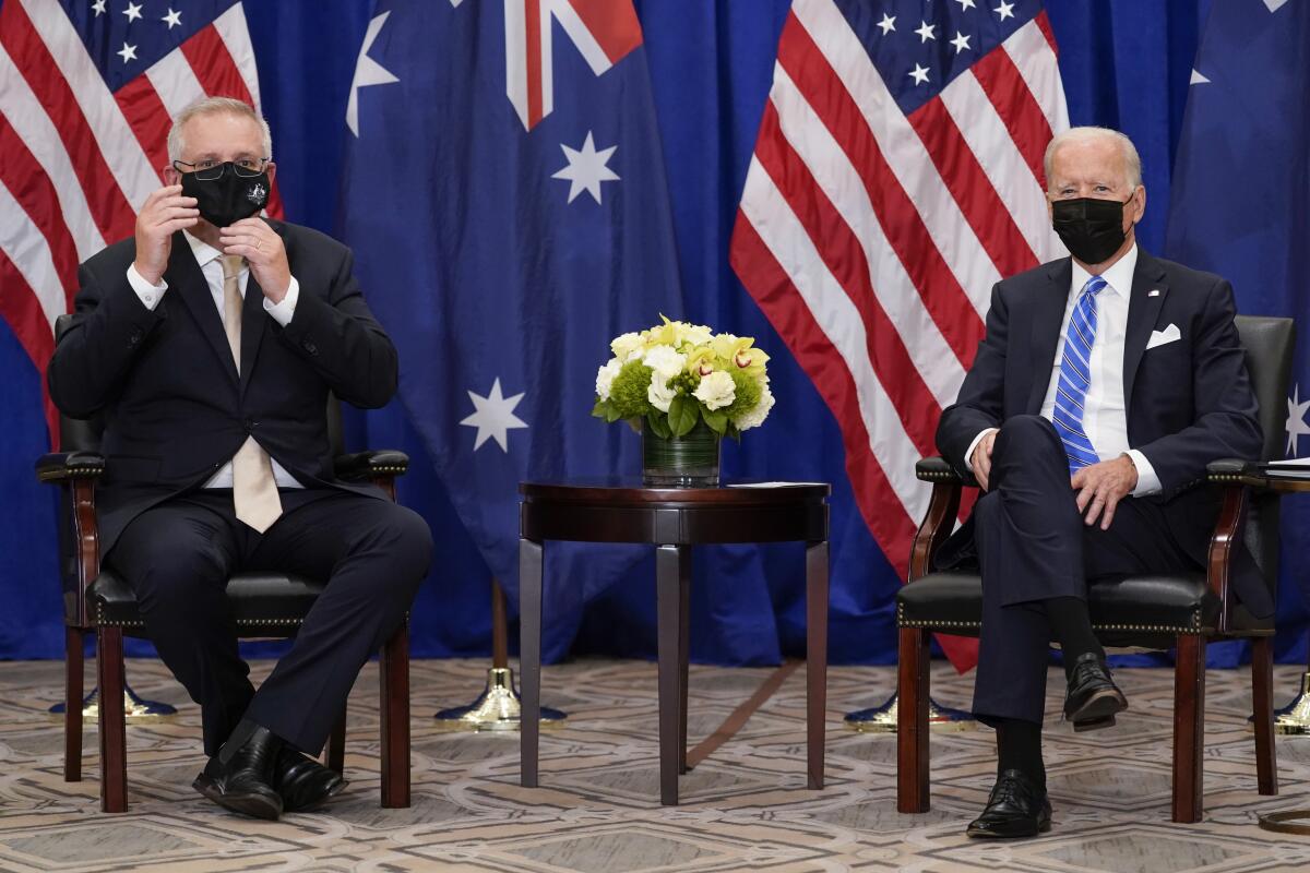 Australian Prime Minister Scott Morrison adjusted his mask during a meeting with President Biden.
