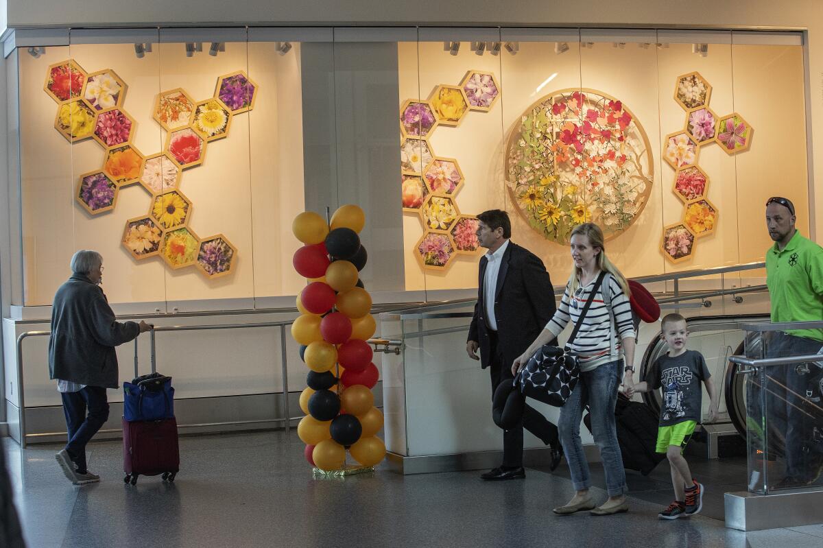 "Floragalora" by artist Pat Warner, an array of hexagons containing 31 digital photo montages Warner created by deconstructing and reassembling her photos, is on display in Terminal 1 at Los Angeles International Airport.