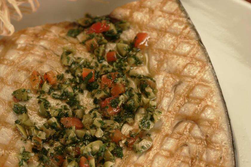 Grilled swordfish with green olive salsa.