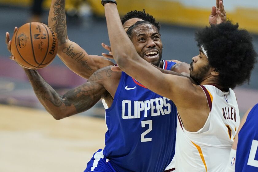 Los Angeles Clippers' Kawhi Leonard (2) drives to the basket against Cleveland Cavaliers' Jarrett Allen (31) during the second half of an NBA basketball game Wednesday, Feb. 3, 2021, in Cleveland. (AP Photo/Tony Dejak)