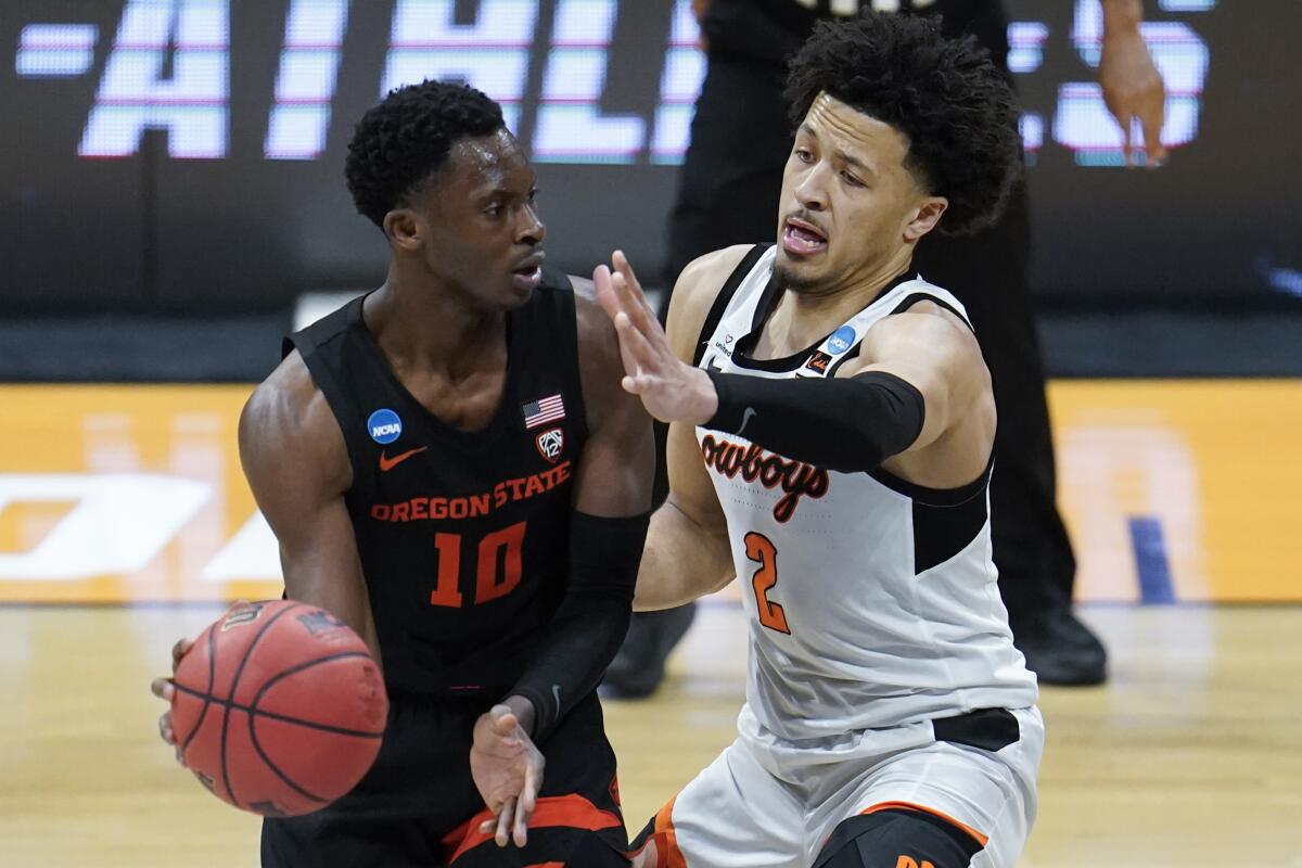 Oklahoma State guard Cade Cunningham applies pressure to Oregon State forward Warith Alatishe.