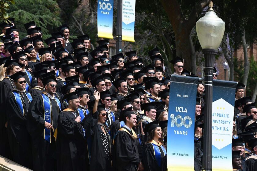 Graduating students pose for a class picture at the University of California Los Angeles (UCLA), June 14, 2019 in Los Angeles California. - With 45 million borrowers owing $1.5 trillion, the student debt crisis in the United States has exploded in recent years and has become a key electoral issue in the run-up to the 2020 presidential elections. "Somebody who graduates from a public university this year is expected to have over $35,000 in student loan debt on average," said Cody Hounanian, program director of Student Debt Crisis, a California NGO that assists students and is fighting for reforms. (Photo by Robyn Beck / AFP)ROBYN BECK/AFP/Getty Images ** OUTS - ELSENT, FPG, CM - OUTS * NM, PH, VA if sourced by CT, LA or MoD **