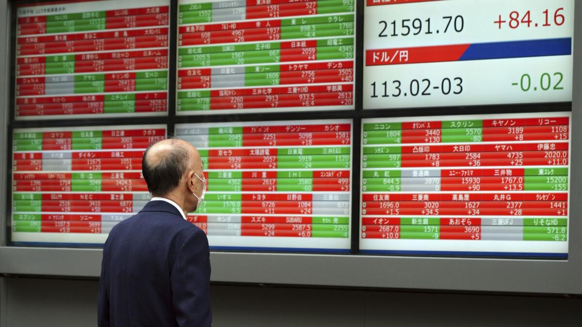 An electronic display board shows stock quotes at a Tokyo securities firm on Thursday.