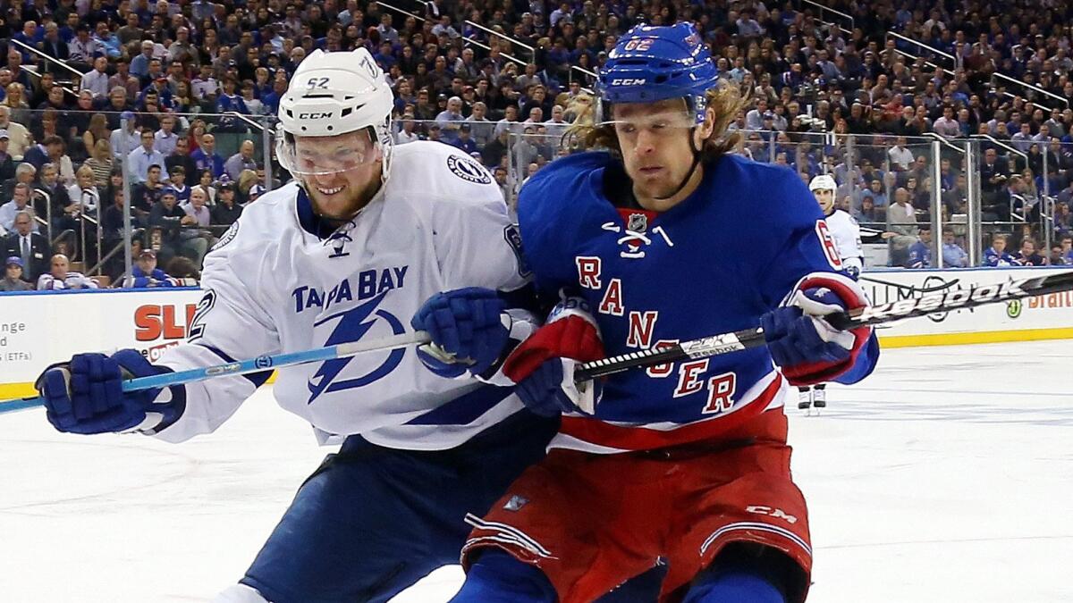 New York Rangers forward Carl Hagelin, right, battles Tampa Bay Lightning defenseman Andrej Sustr during a playoff game on May 29. Hagelin was acquired by the Ducks on June 27.