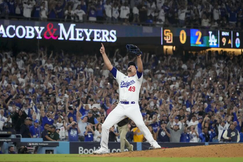 Los Angeles Dodgers relief pitcher Blake Treinen celebrates after the last out in the ninth inning in Game 5 of a baseball NL Division Series against the San Diego Padres, Friday, Oct. 11, 2024, in Los Angeles. (AP Photo/Mark J. Terrill)