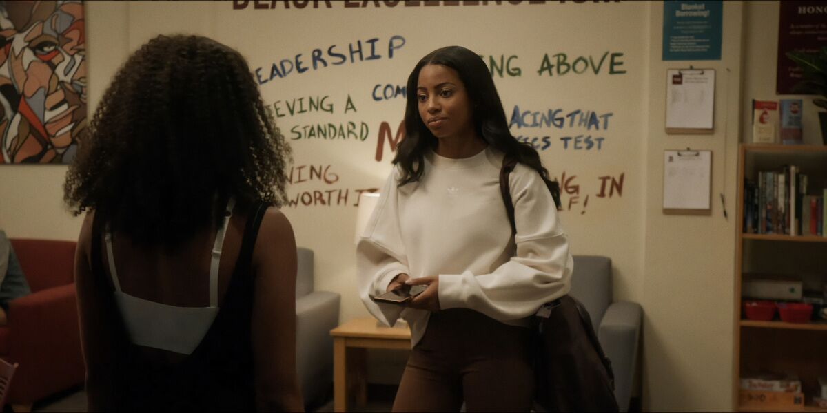 Two students at an HBCU talking before a white board
