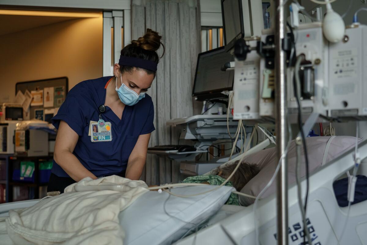 Registered nurse Erin Jenkins provides care for a patient at a San Diego hospital April 18.