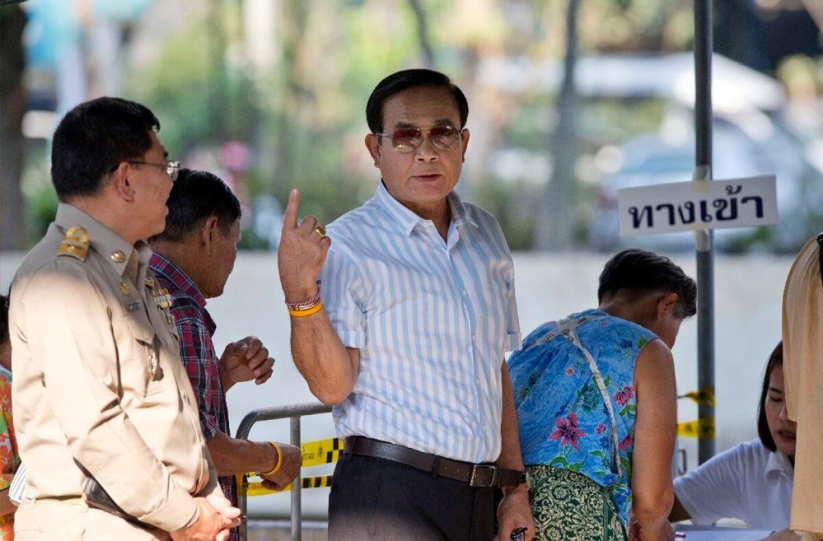 Thai Prime Minister Prayuth Chan-ocha stands in line to vote in Bangkok on March 24, 2019.