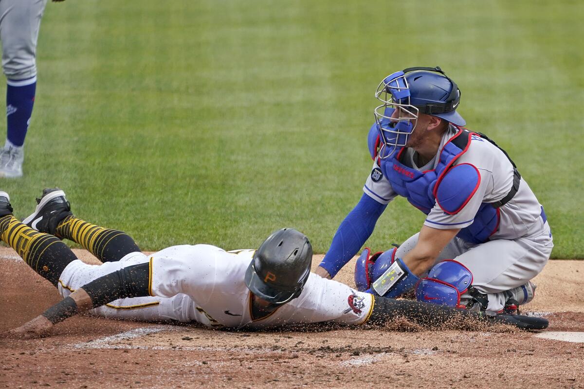 Dodgers catcher Austin Barnes, right, tags out Pittsburgh's Erik Gonzalez.
