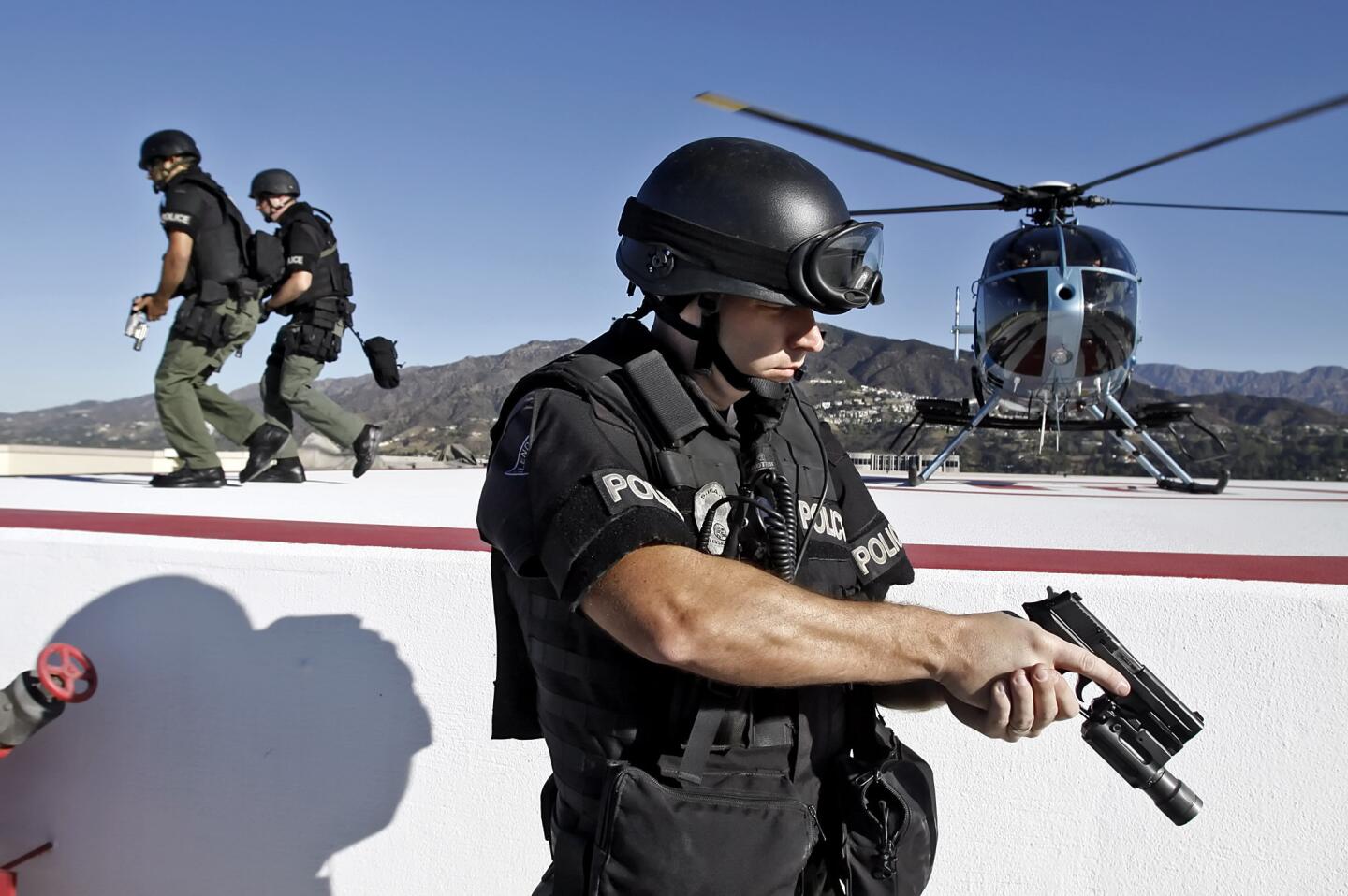 Glendale Police Dept. SWAT officers, including Det. Mike Wenz at front, access 550 N. Brand Blvd. via the roof via helicopter during training exercise on Thursday, October 13, 2011. The scenario included rescuing hostages.