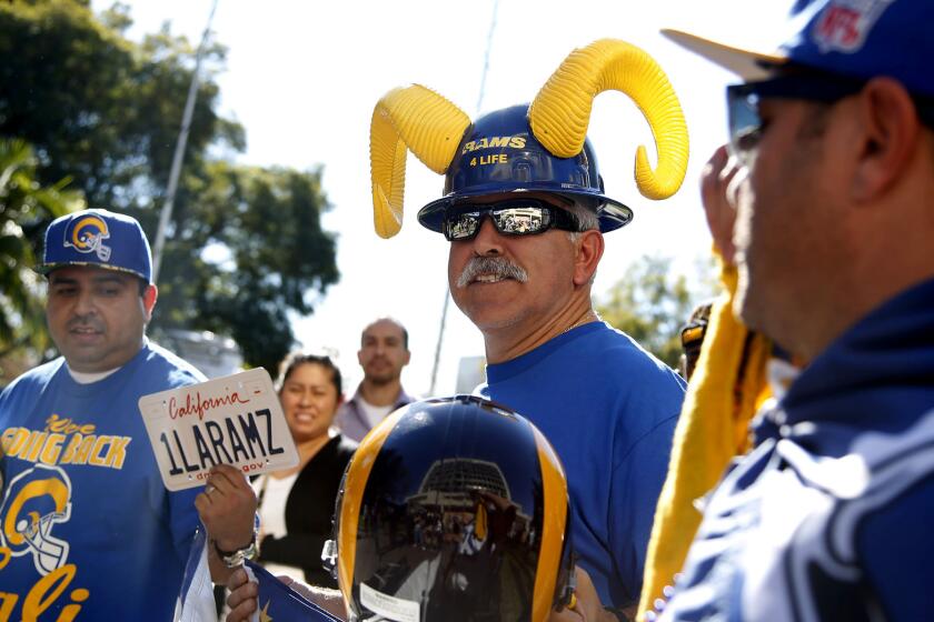 Rams fans (from left) Daniel Palma of Fullterton, Joe Ramirez of Los Angeles, and Skye Sverdlin of Venice attend a news conference held by Inglewood Mayor James T. Butts to discuss a new proposal to incorporate an 80,000-seat sports stadium in a development project at Hollywood Park.