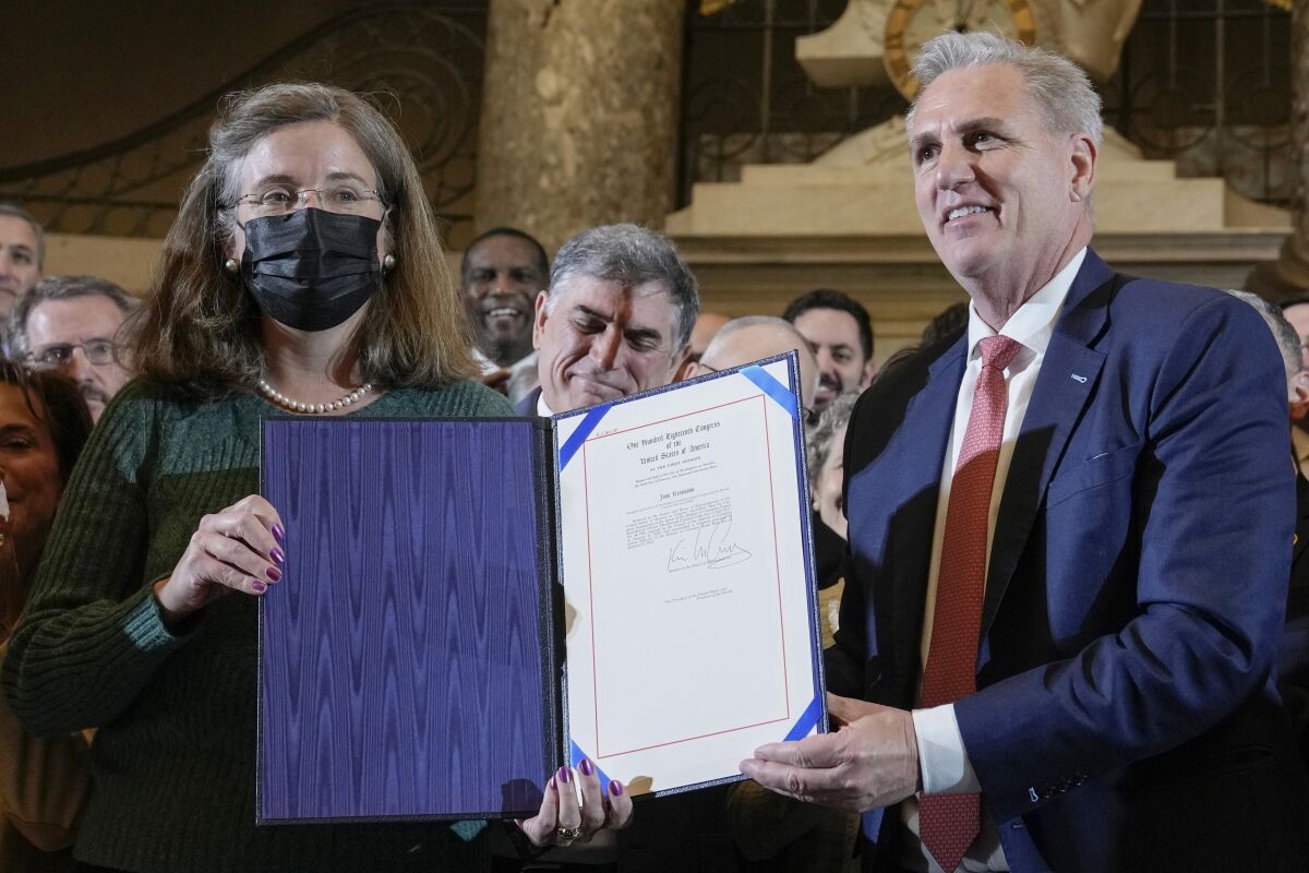 House Speaker Kevin McCarthy of Calif., stands with Denise Rucker Krepp, a former advisory neighborhood commission member, as he holds a ceremony to nullify the D.C. crime bill, Friday, March 10, 2023, on Capitol Hill in Washington. (AP Photo/Mariam Zuhaib)